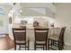 Kitchen with bar stool seating and white cabinetry with stainless appliances at 521 Bent Oak Ct, Spring Hill, FL 34609