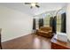 Cozy living room featuring hardwood floors and windows that provide natural light at 521 Bent Oak Ct, Spring Hill, FL 34609