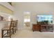 Open concept living area with breakfast bar and view into the bedroom at 521 Bent Oak Ct, Spring Hill, FL 34609