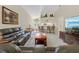 Bright living room features a large leather sofa and view of the kitchen bar at 521 Bent Oak Ct, Spring Hill, FL 34609
