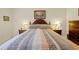Nicely staged main bedroom with wood furniture and attractive linens at 521 Bent Oak Ct, Spring Hill, FL 34609