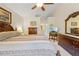 Well-lit main bedroom with detailed furniture and a view into the hallway and en suite bathroom at 521 Bent Oak Ct, Spring Hill, FL 34609