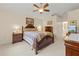 Well-lit main bedroom with detailed wood furniture and views into the hallway and en suite bathroom at 521 Bent Oak Ct, Spring Hill, FL 34609