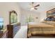Vaulted ceiling bedroom with a large window, detailed wood furniture and neutral toned walls at 521 Bent Oak Ct, Spring Hill, FL 34609