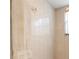 Bathroom shower with neutral tiled walls and a window at 521 Bent Oak Ct, Spring Hill, FL 34609