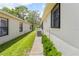 Side yard view showing the home's exterior and green landscaping at 521 Bent Oak Ct, Spring Hill, FL 34609