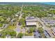 This aerial view shows the community's location near tree-lined streets, roads, and commercial buildings at 556 Virginia St, Dunedin, FL 34698