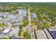 This aerial photo showcases the area's tree-lined streets, roads, commercial buildings, and convenient location at 556 Virginia St, Dunedin, FL 34698