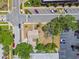 Overhead view of the property shows its location near parking, mature trees, and vibrant community amenities at 556 Virginia St, Dunedin, FL 34698