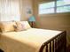 Cozy bedroom featuring a large window, comfortable bed, and charming decorative pillows at 556 Virginia St, Dunedin, FL 34698