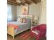 Bright bedroom with a bed, chair, and side table with tasteful décor and ample natural light at 556 Virginia St, Dunedin, FL 34698