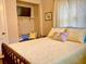 Inviting bedroom boasts a built-in nook, soft, neutral colors, and a comfortable bed with decorative pillows at 556 Virginia St, Dunedin, FL 34698