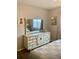 Tastefully decorated bedroom with a dresser, mirror, and art at 556 Virginia St, Dunedin, FL 34698