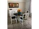 Inviting dining area with a round table, elegant chairs, and bright natural light at 556 Virginia St, Dunedin, FL 34698