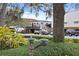 Charming commercial space with mature trees, a decorative fountain, and well-maintained landscaping at 556 Virginia St, Dunedin, FL 34698