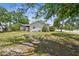 A cozy home with well-kept exterior, featuring mature trees and landscaping, situated on a well-maintained lot at 556 Virginia St, Dunedin, FL 34698