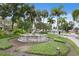 Lush landscape featuring a beautiful water fountain with elegant crane sculptures, perfect for a tranquil escape at 556 Virginia St, Dunedin, FL 34698