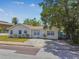 Well-maintained home with inviting curb appeal, featuring a neatly landscaped front yard at 556 Virginia St, Dunedin, FL 34698