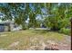 Spacious front yard, mature trees and proximity to the road create a welcoming outdoor space at 556 Virginia St, Dunedin, FL 34698