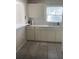 Efficient kitchen with neutral cabinetry, ample counter space, and a large window at 556 Virginia St, Dunedin, FL 34698