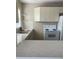 Functional kitchen featuring classic appliances, hexagon tiled counter, and bright natural light at 556 Virginia St, Dunedin, FL 34698