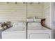 Convenient laundry room with washer and dryer units, featuring practical storage solutions at 556 Virginia St, Dunedin, FL 34698