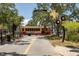 View of the Dunedin trolley parked on a brick road near storefronts at 556 Virginia St, Dunedin, FL 34698