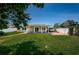 Expansive backyard with covered patio, lush lawn, and convenient access to a covered carport at 5785 15Th N Ave, St Petersburg, FL 33710