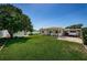 Spacious backyard with lush green grass, a covered patio, and a shed for storage at 5785 15Th N Ave, St Petersburg, FL 33710