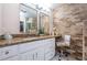 Charming bathroom features a white vanity, granite countertops, and unique stone accent wall at 5785 15Th N Ave, St Petersburg, FL 33710