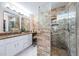 Beautiful bathroom features a glass enclosed shower with stone tile and granite countertops at 5785 15Th N Ave, St Petersburg, FL 33710