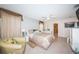 A spacious bedroom features neutral paint, tile floors, a ceiling fan, and draped windows at 5785 15Th N Ave, St Petersburg, FL 33710