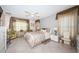 A bright bedroom features neutral paint, tile floors, a ceiling fan, and draped windows at 5785 15Th N Ave, St Petersburg, FL 33710
