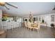 Spacious dining room with elegant chandelier, decorative wall panels, and breakfast bar access at 5785 15Th N Ave, St Petersburg, FL 33710