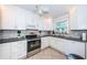 Modern kitchen featuring white cabinetry, stainless steel appliances, and granite countertops at 5785 15Th N Ave, St Petersburg, FL 33710