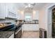 Bright kitchen featuring white cabinetry, stainless steel appliances, and granite countertops at 5785 15Th N Ave, St Petersburg, FL 33710