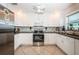 Modern kitchen featuring white cabinetry, stainless steel appliances, and elegant granite countertops at 5785 15Th N Ave, St Petersburg, FL 33710