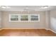 Bedroom featuring hardwood floors, neutral walls, and good window light at 6006 N Highland Ave, Tampa, FL 33604
