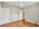 Freshly painted bedroom with hardwood floors and built-in bookshelf at 6006 N Highland Ave, Tampa, FL 33604
