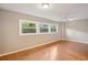 Bedroom featuring hardwood floors, neutral walls, and good window light at 6006 N Highland Ave, Tampa, FL 33604