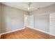 Cozy bedroom with hardwood floors, fresh paint, and a built-in bookshelf at 6006 N Highland Ave, Tampa, FL 33604