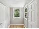 Bright entryway featuring wood-look floors, neutral paint, and natural light from two windows at 6006 N Highland Ave, Tampa, FL 33604