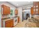Well-lit kitchen with granite countertops and a stainless steel refrigerator at 6006 N Highland Ave, Tampa, FL 33604