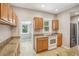 Galley kitchen featuring granite countertops, ample cabinet space, and modern appliances at 6006 N Highland Ave, Tampa, FL 33604