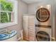 Well-lit laundry room equipped with modern, stainless steel washer and dryer at 6006 N Highland Ave, Tampa, FL 33604