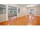 Bright and airy living room with gleaming hardwood floors, neutral walls, and views of the neighborhood at 6006 N Highland Ave, Tampa, FL 33604