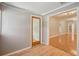 Bright living room area featuring wood-look flooring and a doorway to the adjacent space at 6006 N Highland Ave, Tampa, FL 33604