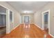 Spacious living room with gleaming hardwood floors, neutral walls, and an open layout at 6006 N Highland Ave, Tampa, FL 33604