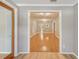 Bright living room featuring wood-look flooring and a view of the adjacent spaces at 6006 N Highland Ave, Tampa, FL 33604