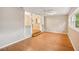 Living room with wood floors, fresh paint, and a view of the dining area at 6006 N Highland Ave, Tampa, FL 33604